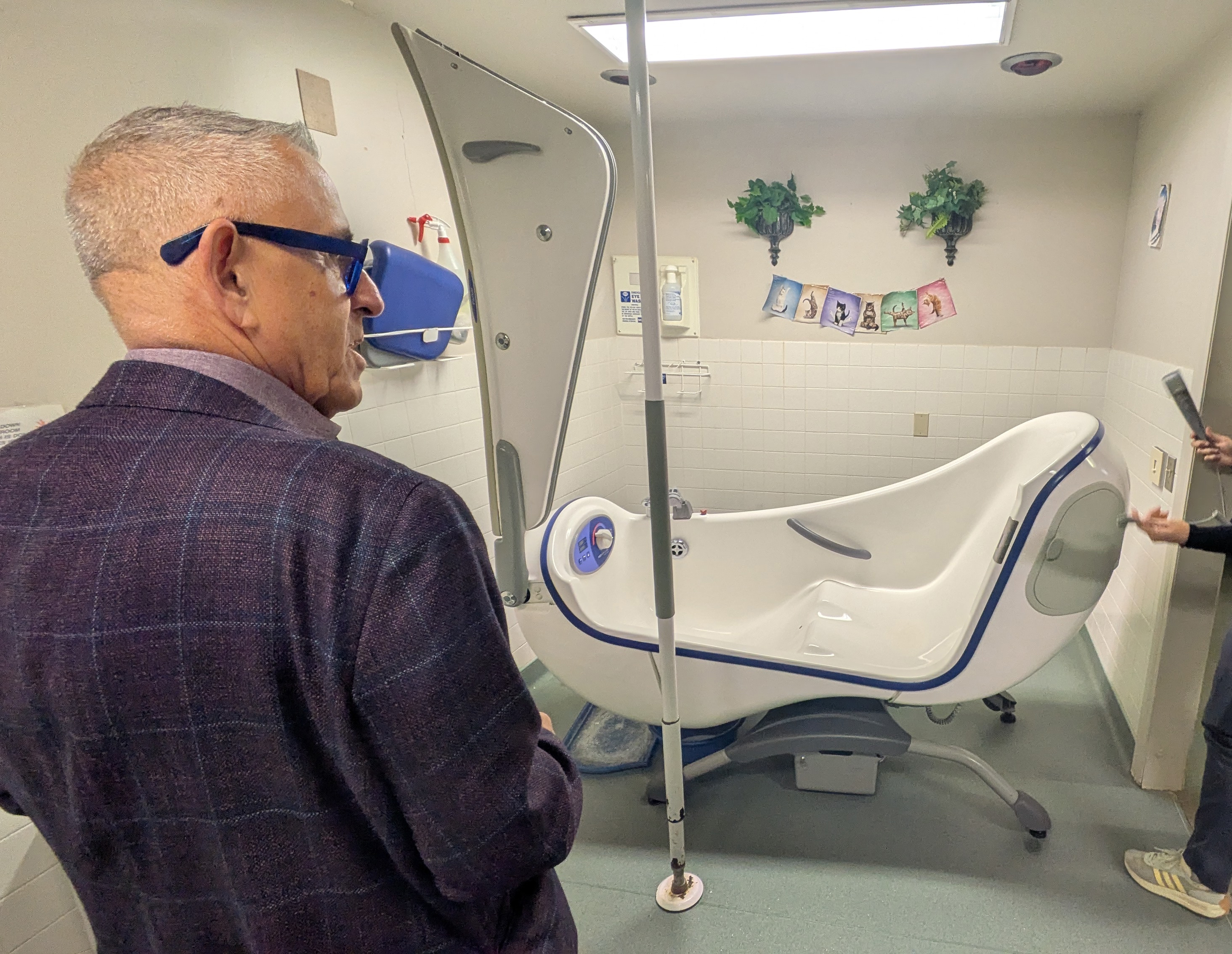 MLA Jeff Bereza and Portage District Hospital Foundation executive viewing the old tub