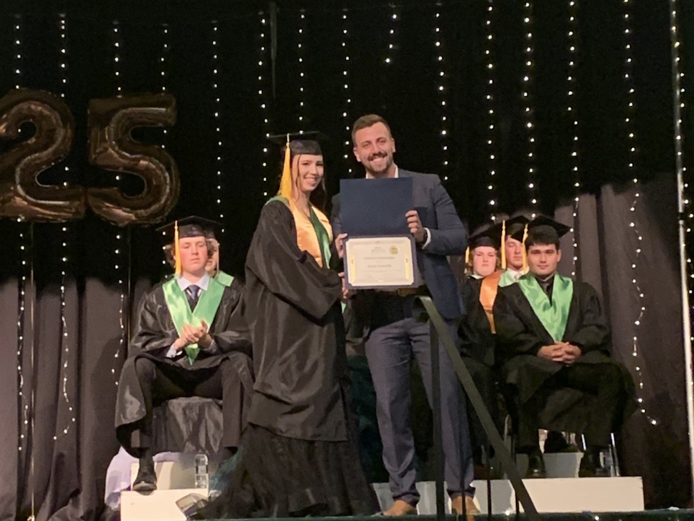graduation ceremony where a young woman recieves a special award
