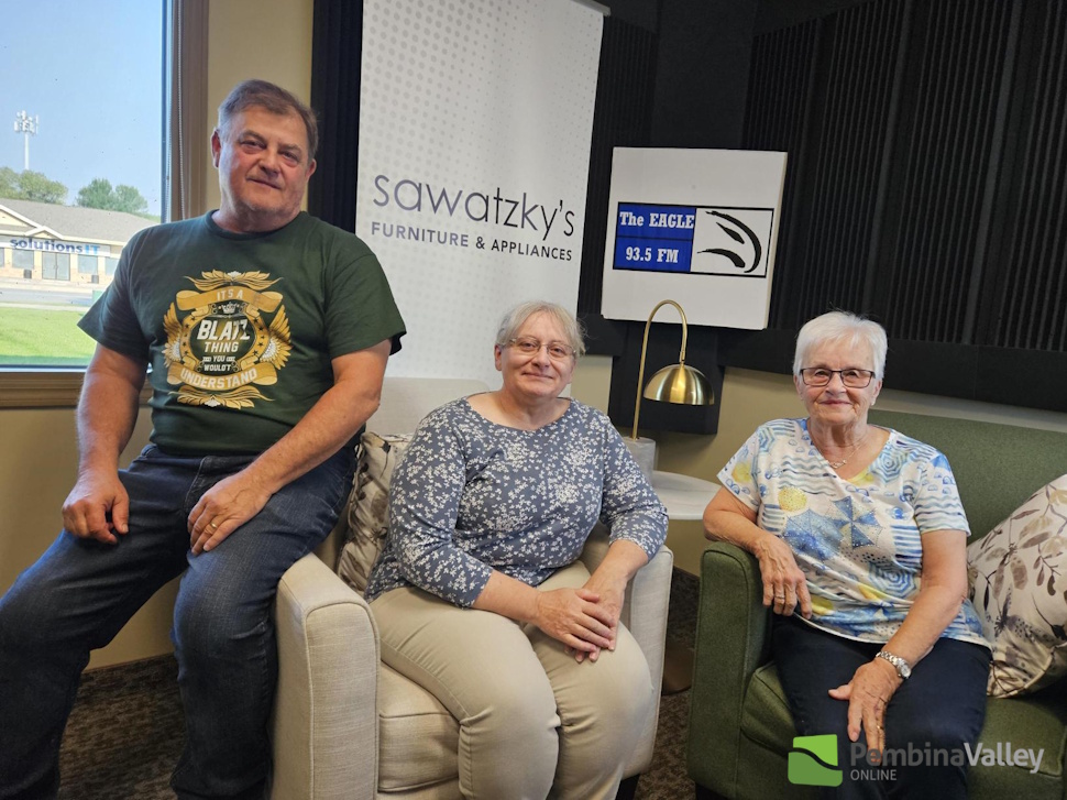 three people sit in a studio