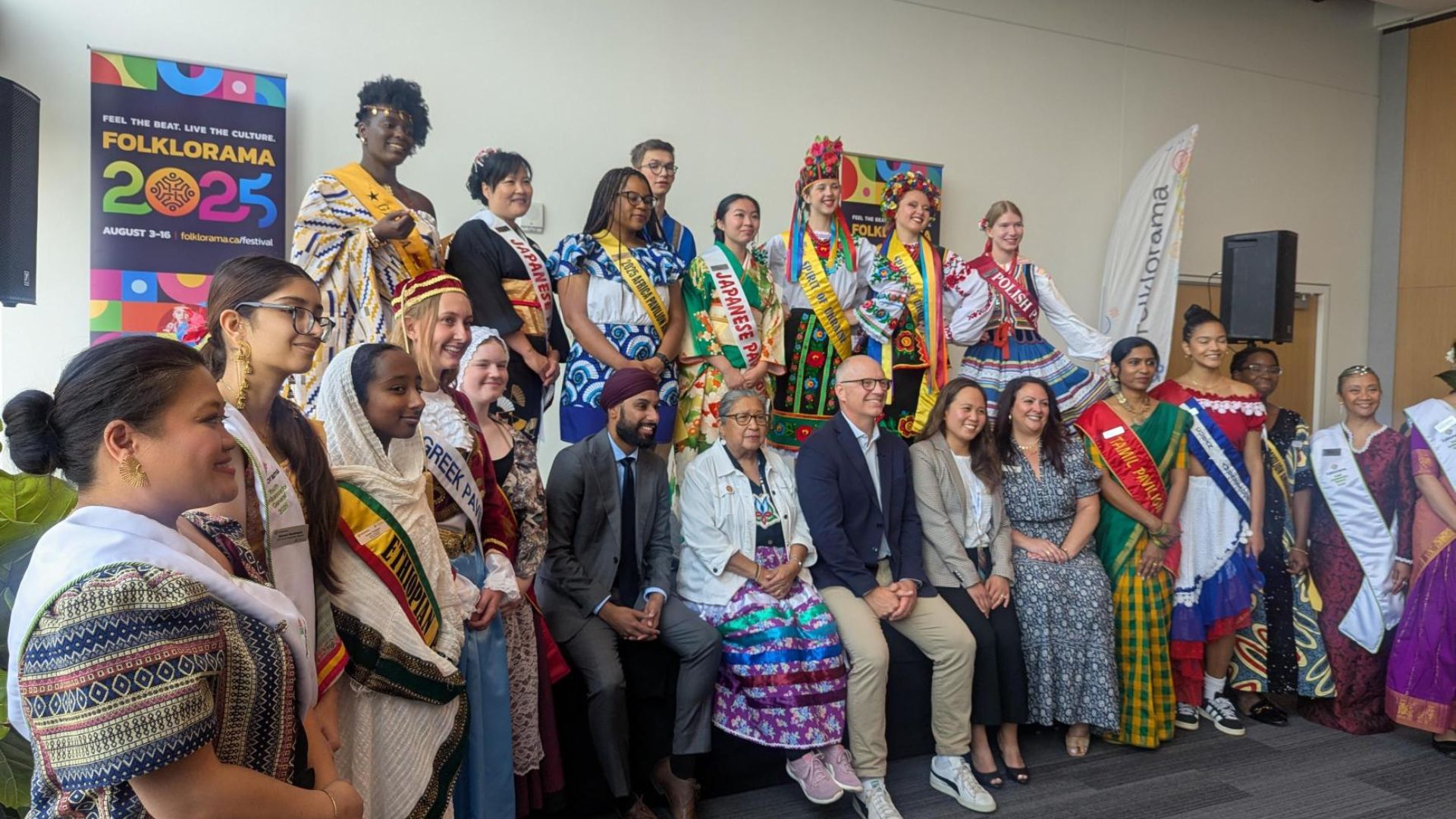 People posing for a picture dressed in different cultural apparel