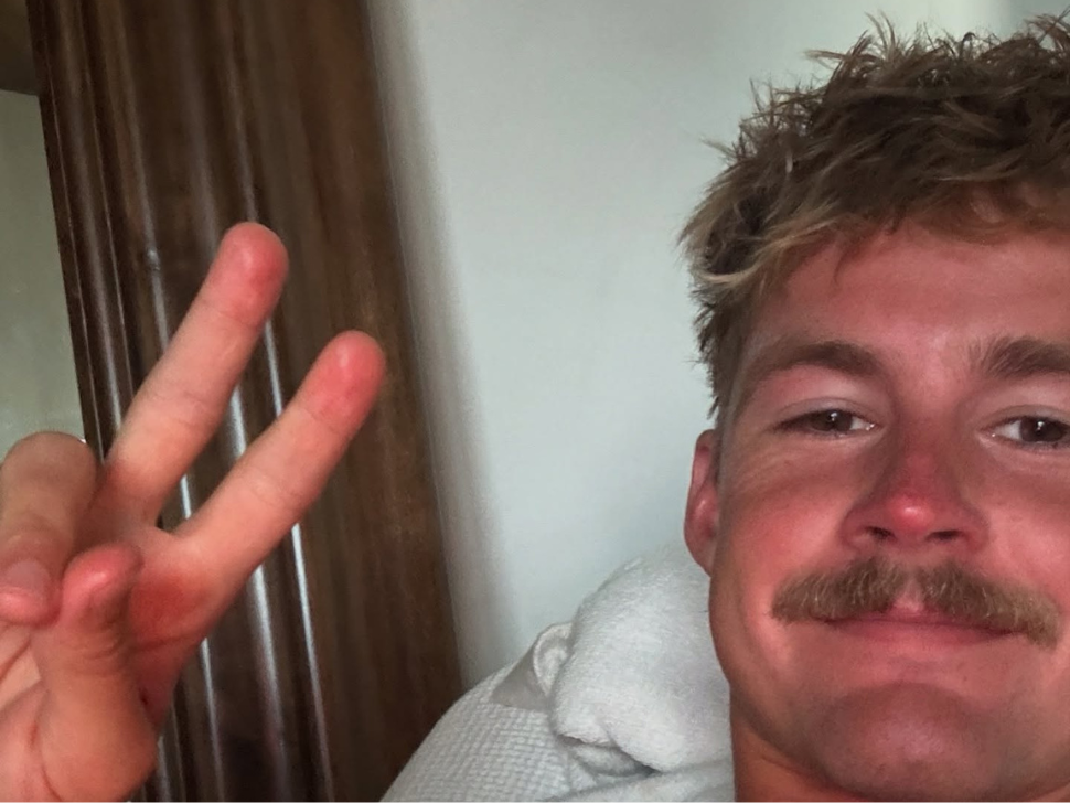 Forrest Frank gives the peace sign as he recovers from a broken back
