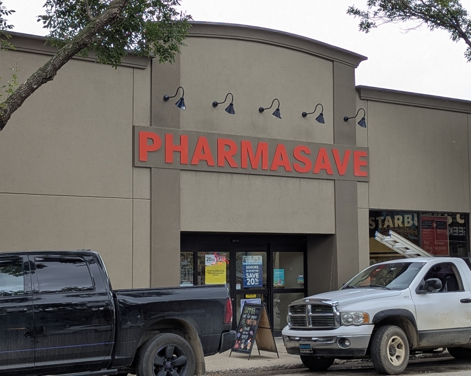 An exterior of a brown building storefront with red letters on teh top
