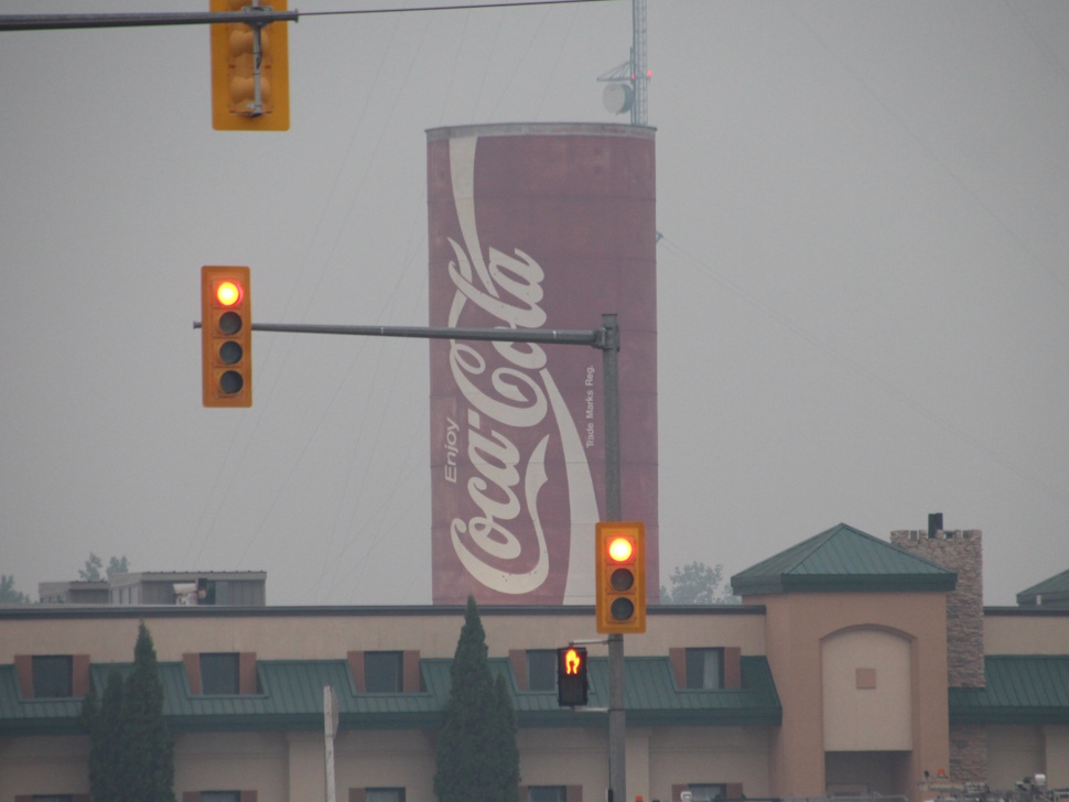 Smoke from nearby wildfires blankets the air around the iconic giant Coca-Cola can landmark in Portage la Prairie.