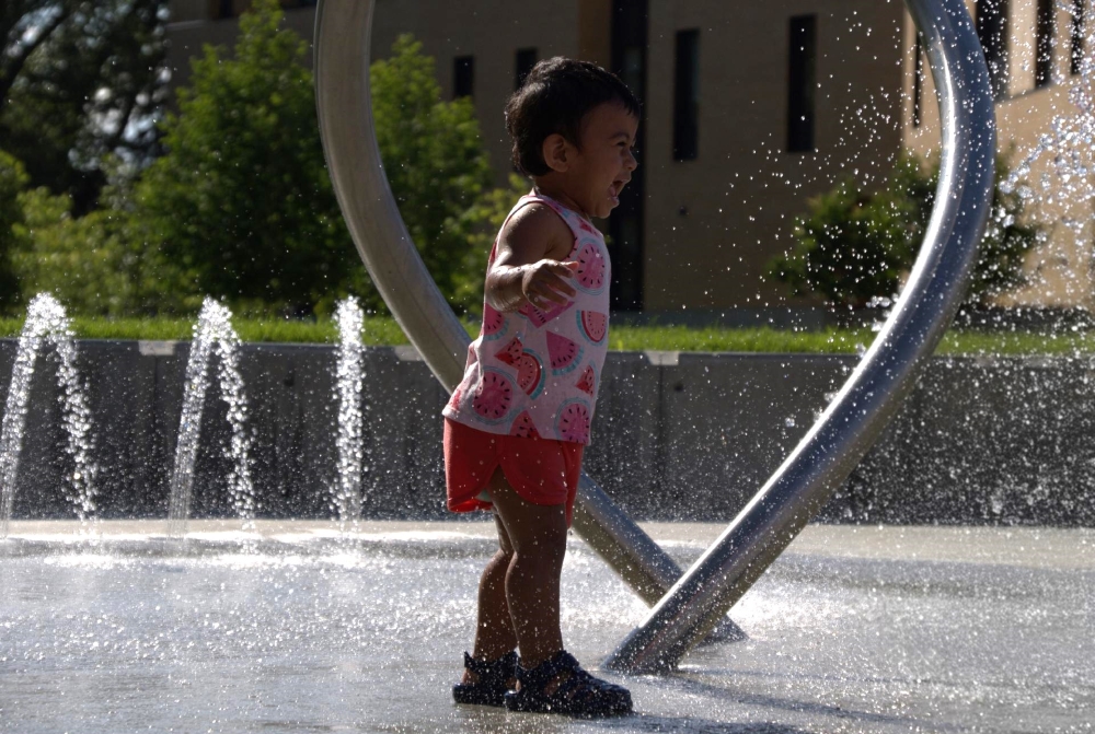 A child playing in the water at the newly unveiled Hartley Hub.