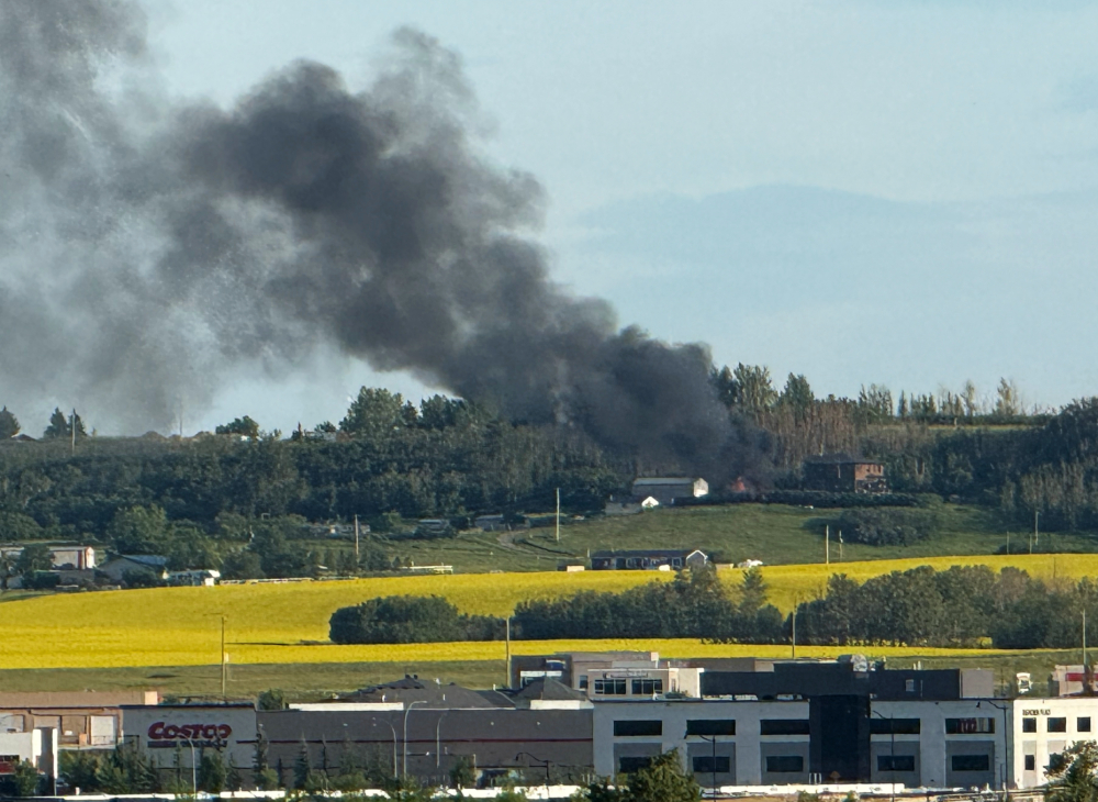A plume of black smoke rising from the fire.