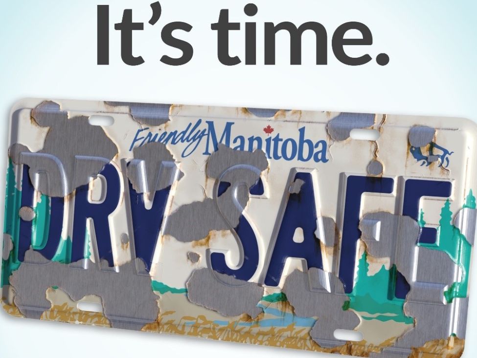 a Manitoba license plate that is wearing down so the letters are hard to read