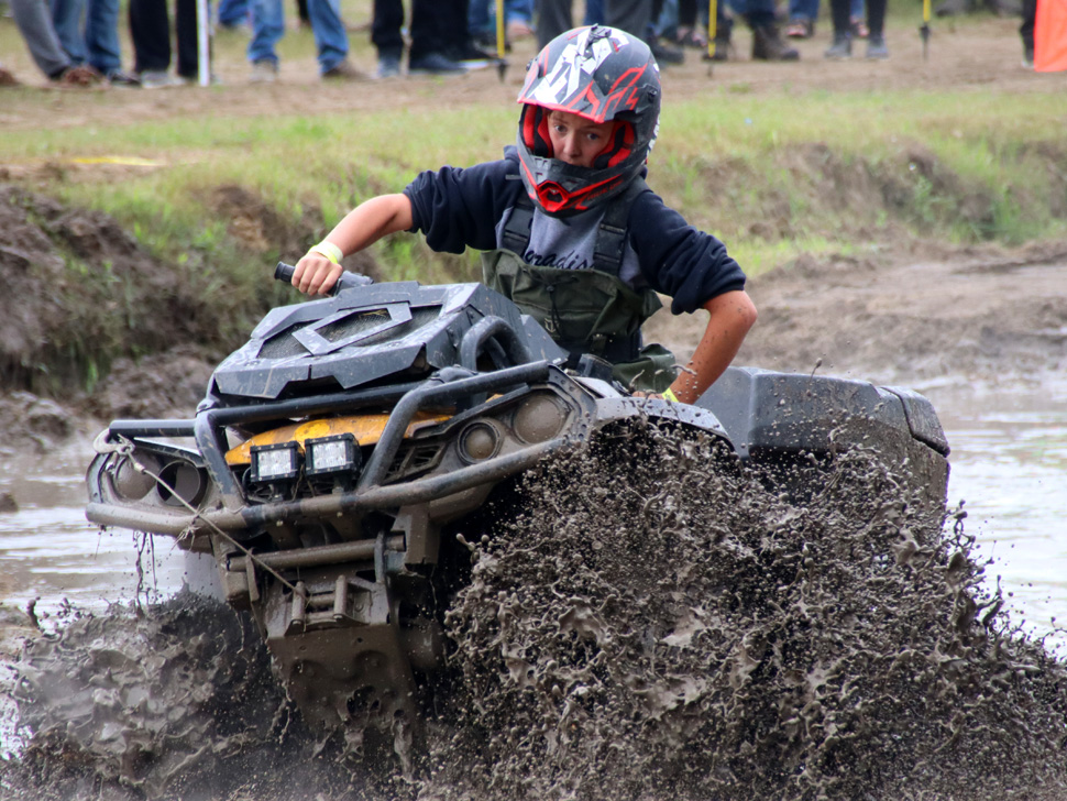 Driving an ATV through a mud bog