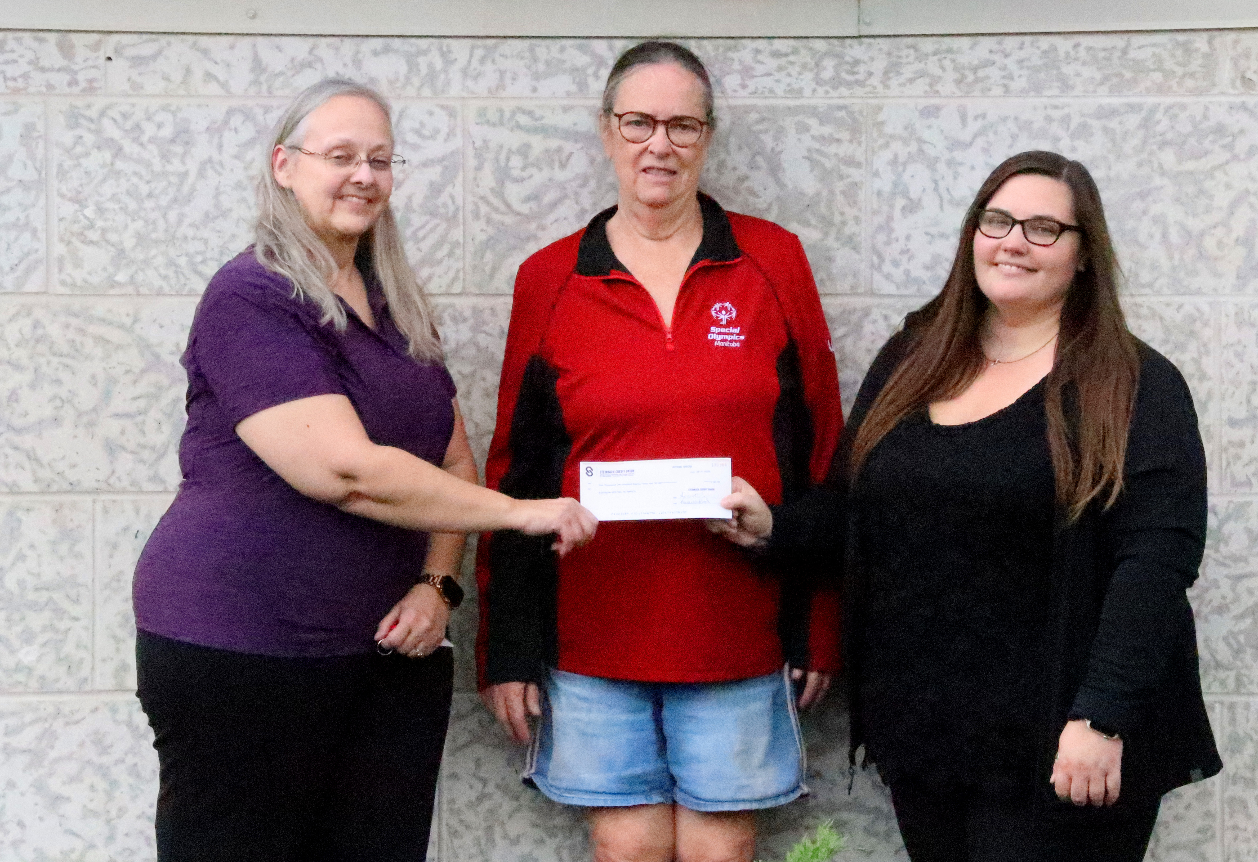 Cathy Weibe receiving a check from SCU representatives