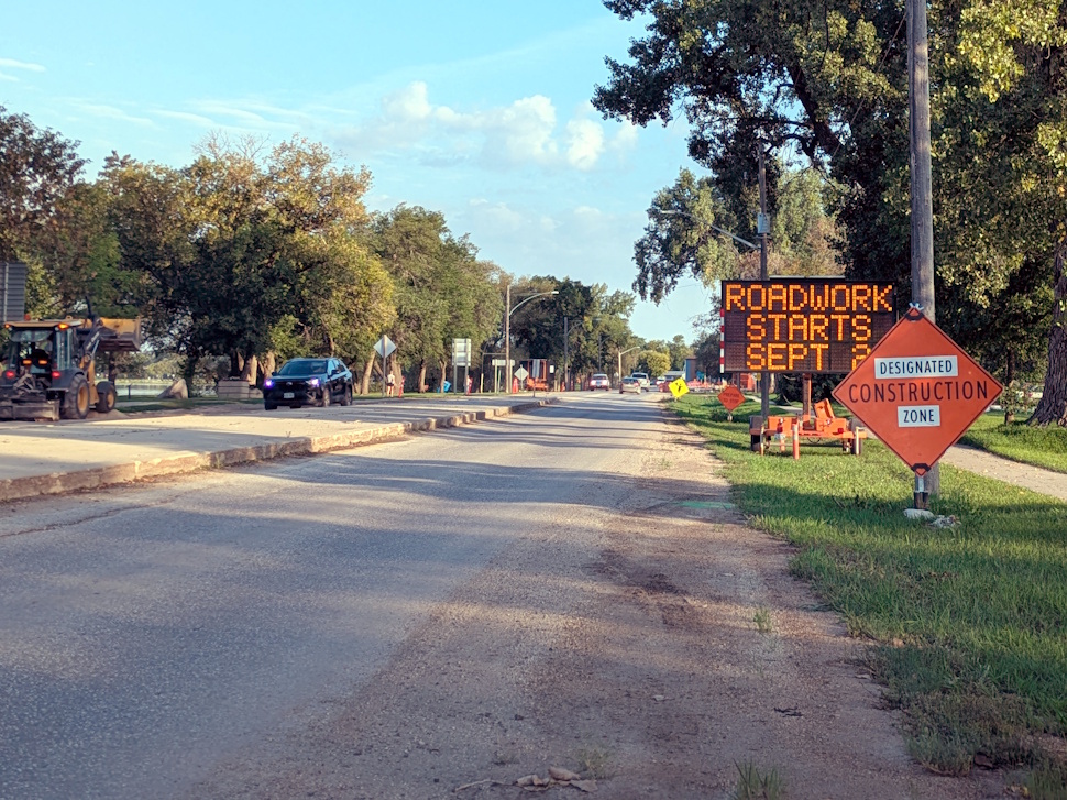 A large warning sign alerts drivers to lane closures and flagging on PR 240 in Portage la Prairie as surface rehabilitation work begins.
