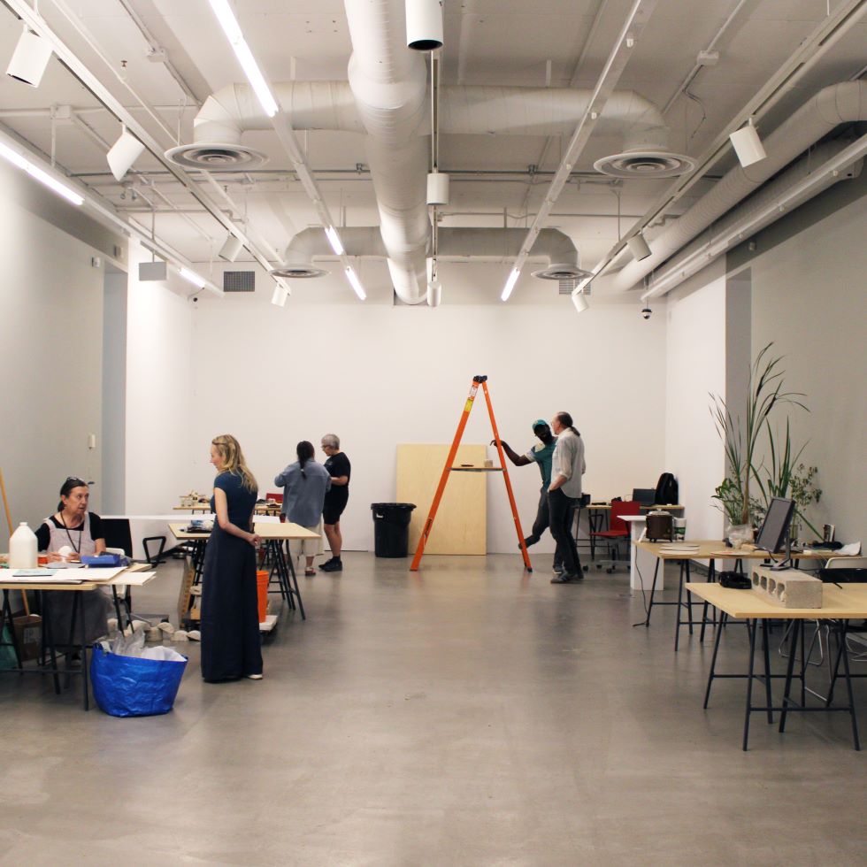 Participants in the Plug In Institute of Contemporary Art's Summer Institute preparing for the Open Studio event.