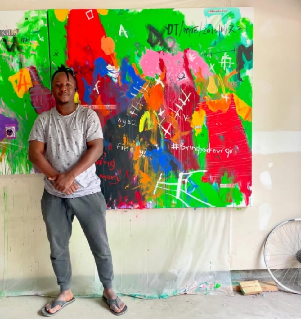 Habeeb Andu in front of a work from 'Theatre of War'. (Source: 226 Gallery)