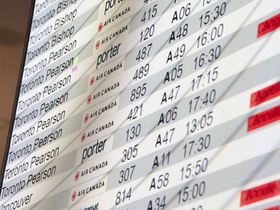 A departure board is seen at Montreal-Pierre Elliott Trudeau International Airport in Dorval, Que., on Tuesday, Aug. 19, 2025. THE CANADIAN PRESS/Christinne Muschi