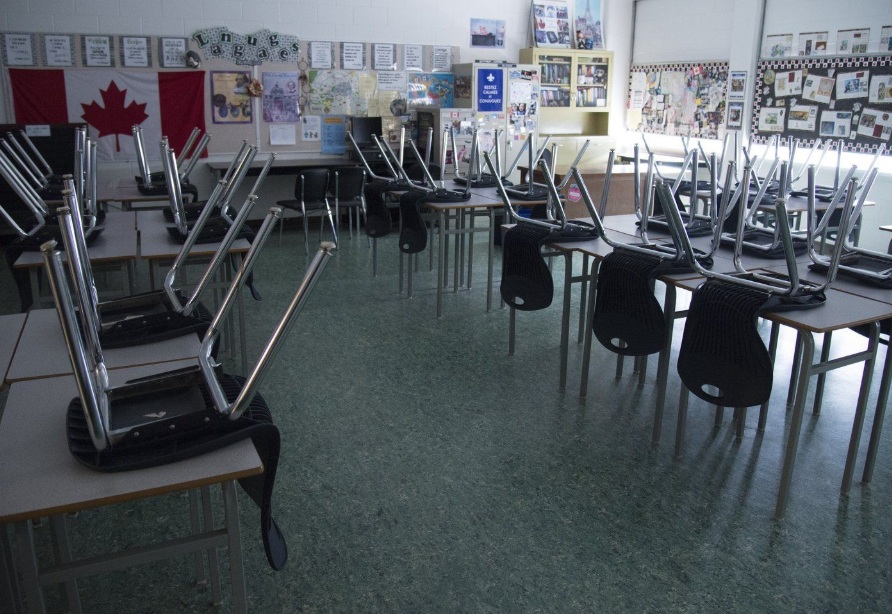An empty classroom is pictured at Eric Hamber Secondary school in Vancouver, B.C., on Monday, March 23, 2020. THE CANADIAN PRESS/Jonathan Hayward