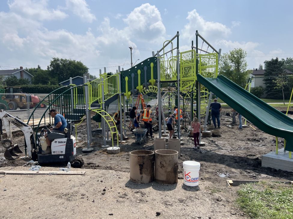 people building a playground structure