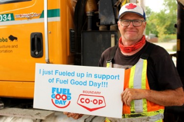 a bus driver holding up a sign for Co-op