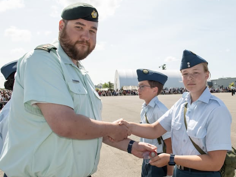 Geri Orchard receives an award at summer cadet graduation parade.