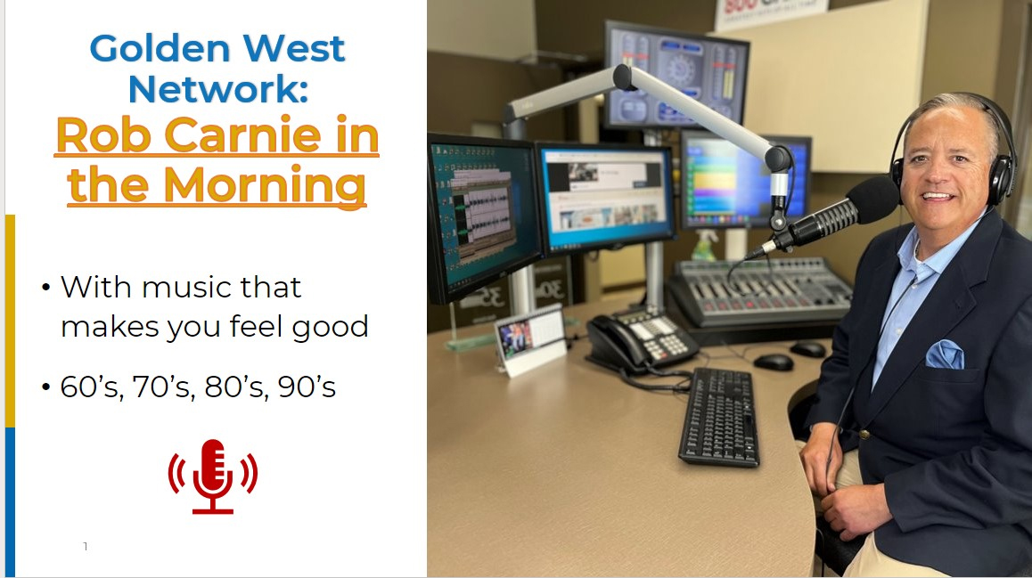 CHAB's Rob Carnie is in this photo, posing and smiling at the controls in the CHAB studio
