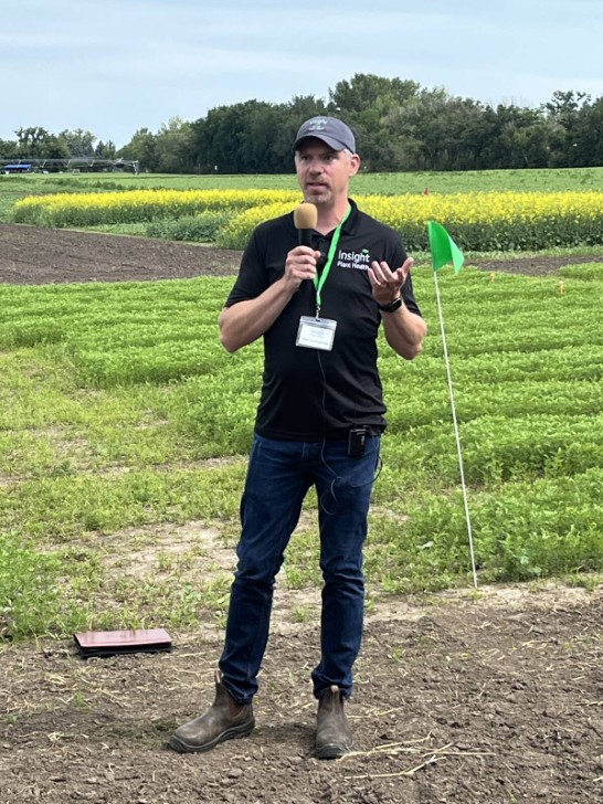   Dave Greenshields Insight Plant Health talks into a microphone during a field day 