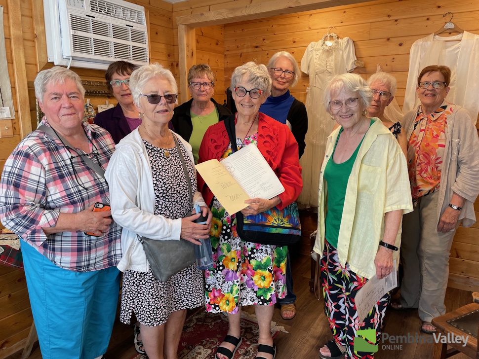 A group of women with one carrying a book