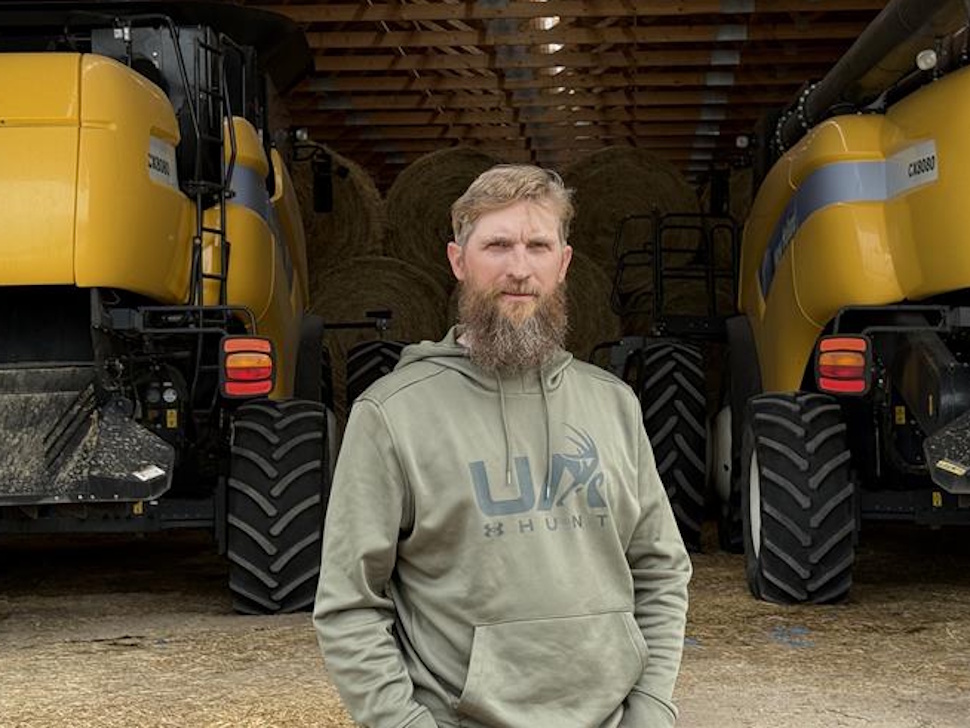 a man stands in front of his combines