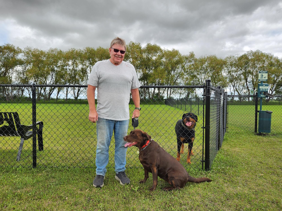 Mayor Daryl Shipman and his dog, Bella, enjoy the fresh air at WestLake-Gladstone’s newly opened dog park. PortageOnline/Tristen Sokolosky