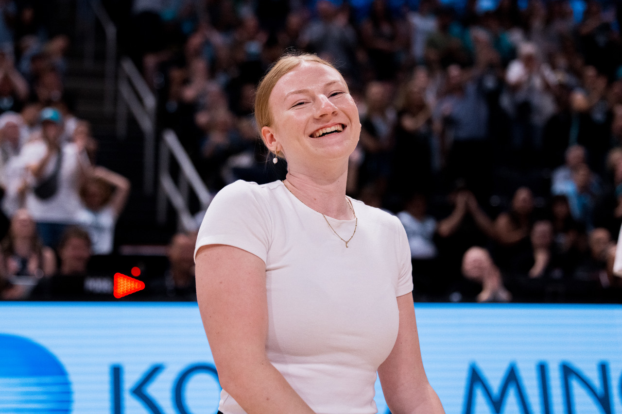 Sydney Last smiling on the court of a Winnipeg Sea Bears game.