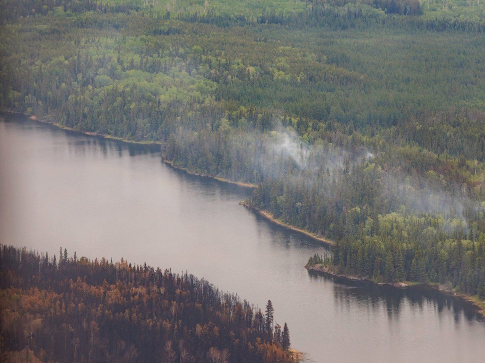 The northern Manitoba town of Snow Lake has been given the go-ahead to return home later this week after being displaced due to wildfires. Trees burned by wildfires in northern Manitoba are shown during a helicopter tour in the surrounding area of Flin Flon, Man. on Thursday, June 12, 2025. THE CANADIAN PRESS/Mike Deal