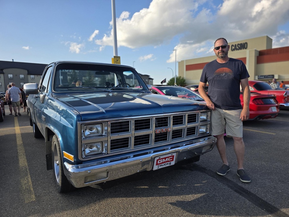 Stuart Lawrence stands behind his long time companion, his 1981 GMC Sierra. (photos by Hayden Michaels)