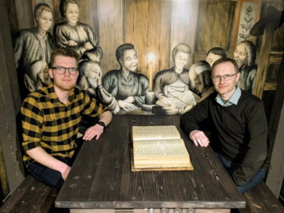 Jonathan Krause (left) and Peter Harder (right) inside on of the displays depicting an early meeting of the Anabaptist movement in the 1520s. (submitted)
