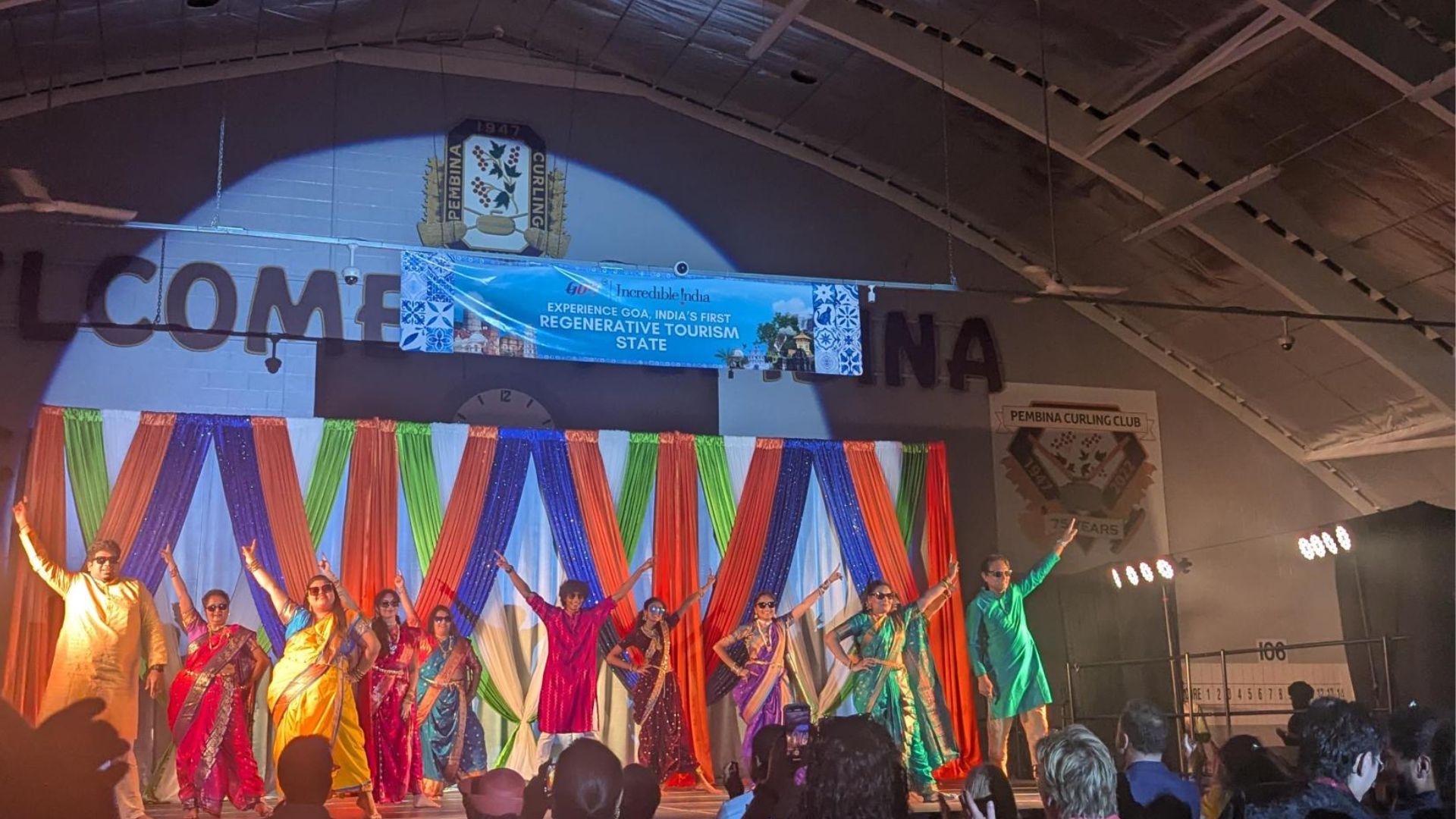 Dancers on stage in Indian attire.