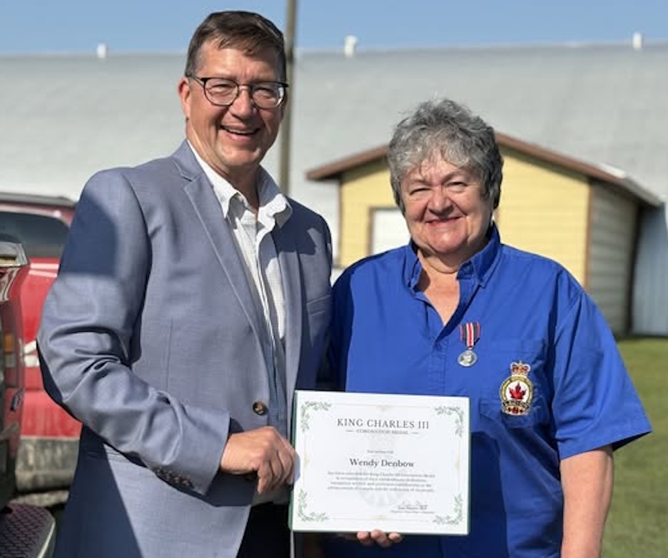 MP Dan Mazier presenting the King Charles III Coronation Medal certificate to Wendy Denbow during a ceremony in Plumas, Manitoba.