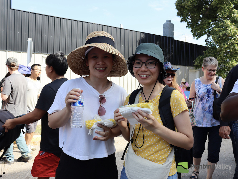 Festival goers enjoy corn on the cob