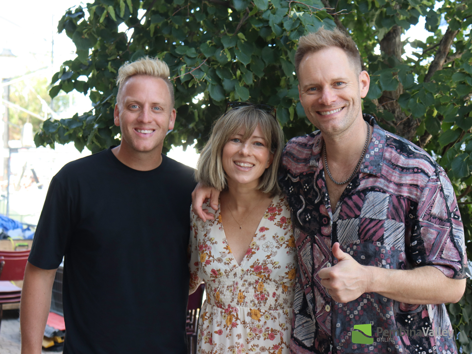 three people pose in a photo 