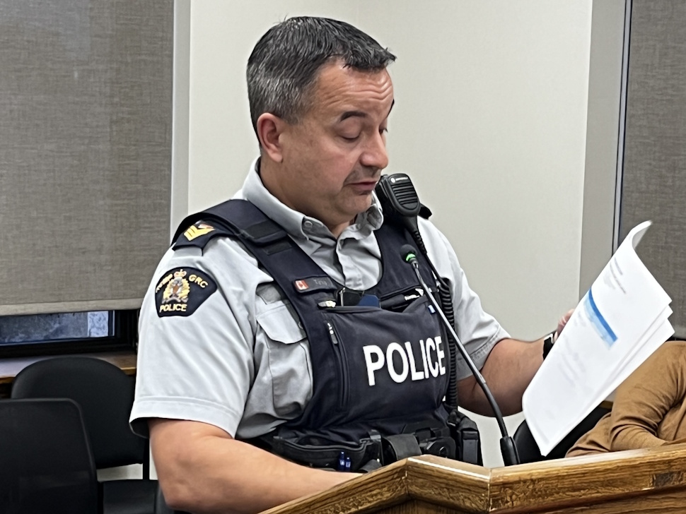 Staff Sergeant Darcy Turko of the Portage la Prairie RCMP speaks at the August 11 city council meeting, presenting the quarterly policing report alongside CSO program updates.