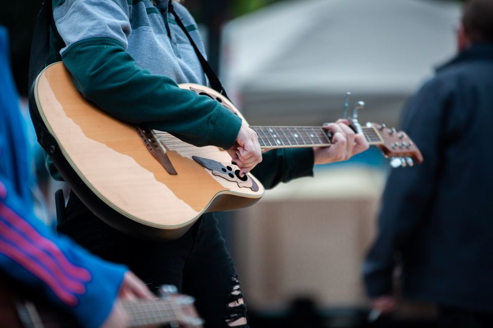 a man playing an acoustic guitar