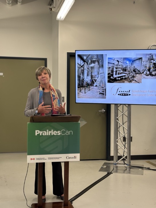  Prairies Can Minister Eleanor Olszewski standing behind a podium 
