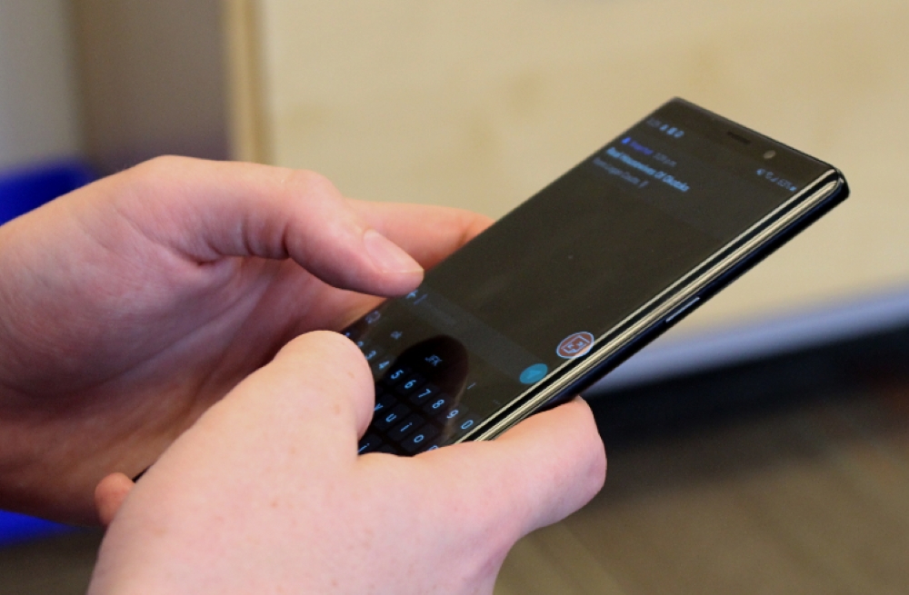 Hands holding a cell phone