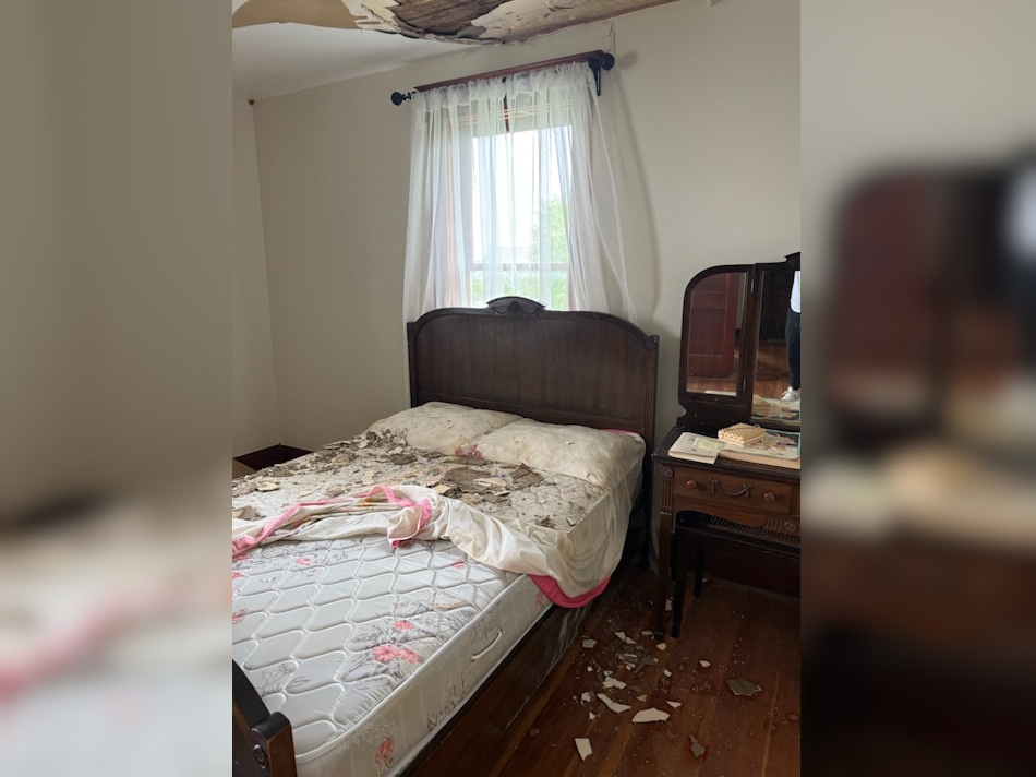 Case House ceiling crashes in showing debris on antique bed