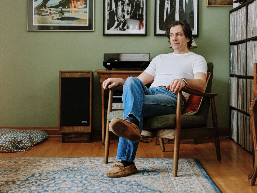 Grant Davidson sitting in chair in home