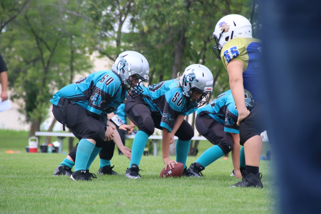 Raiders football players on field