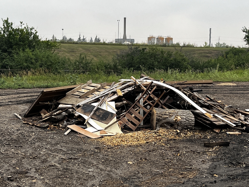 Pile of discarded lumber, tires, and concrete debris illegally dumped at the Portage la Prairie tree disposal site.