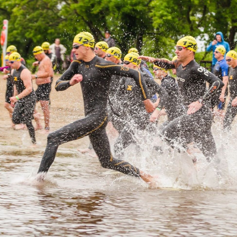 Athletes running into a lake