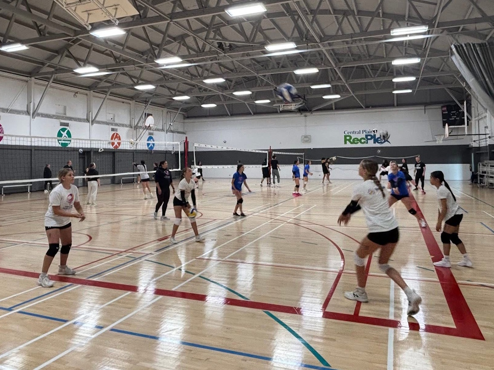 Portage Hurricanes volleyball team gathered on the court during practice at a summer training camp.