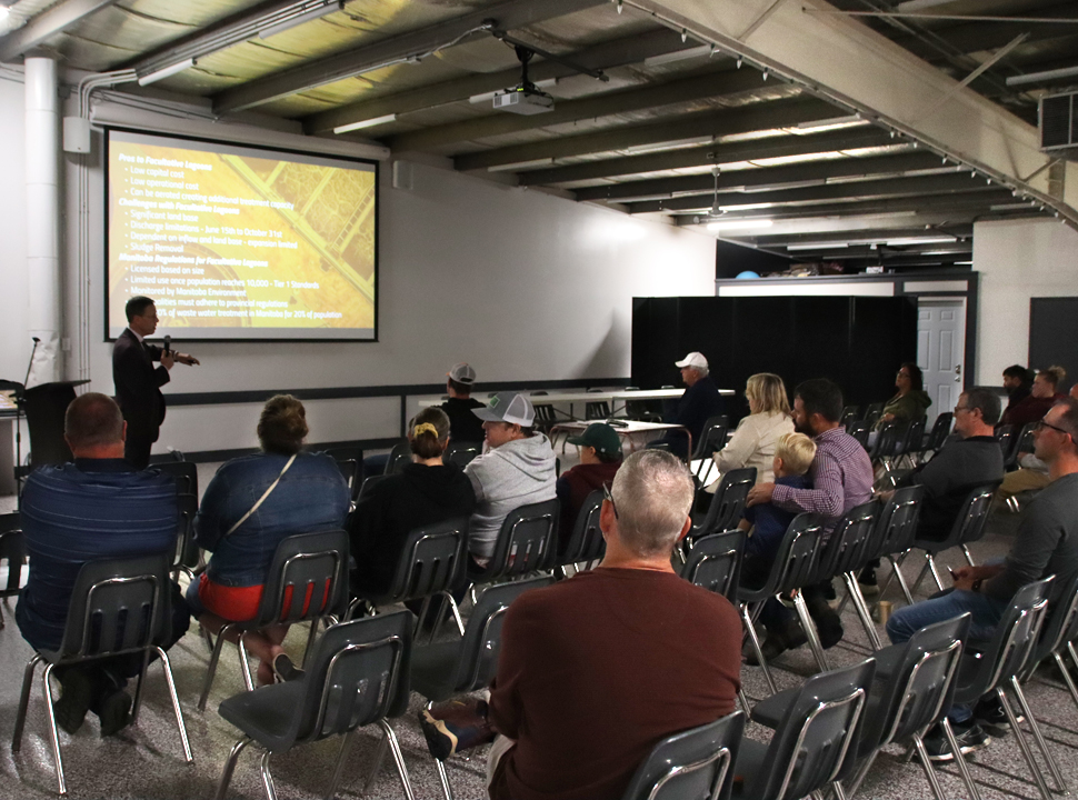 a group of people in chairs look at a presentation on a project