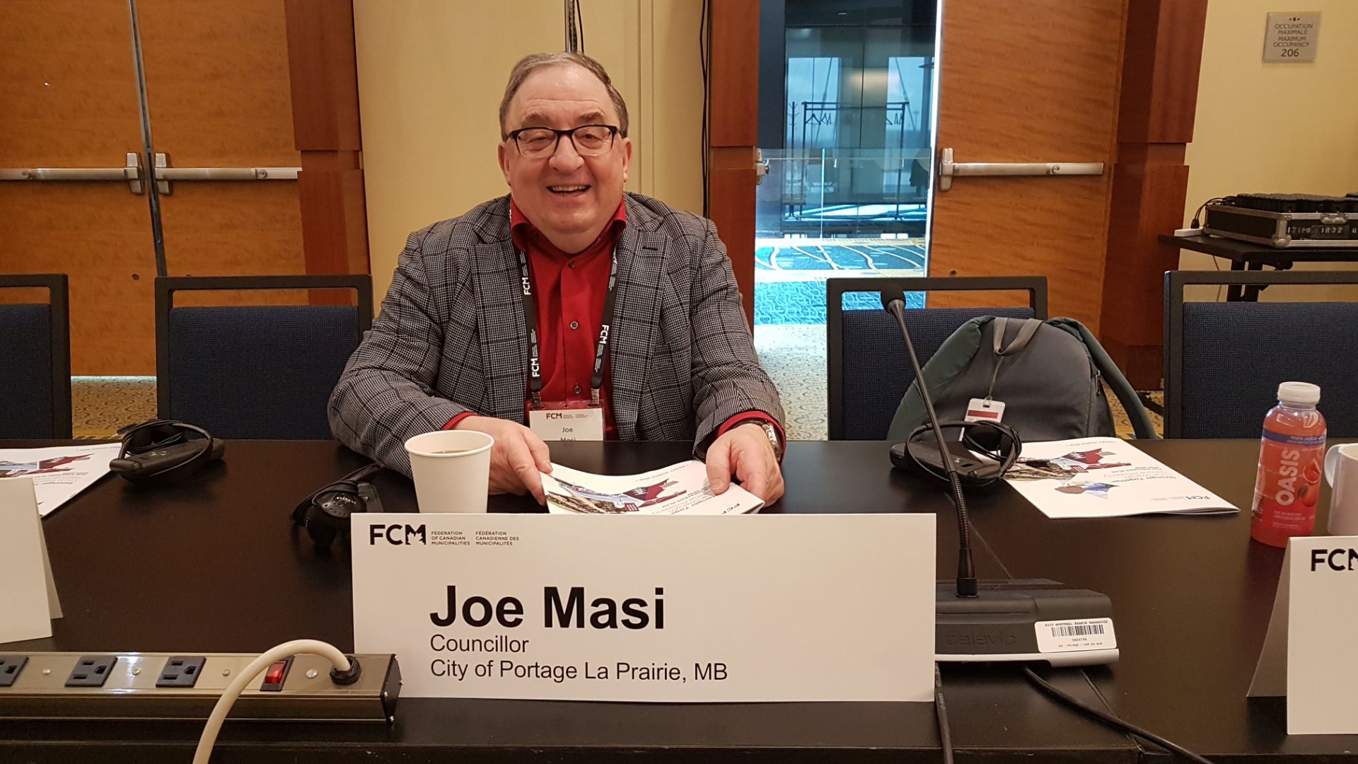 Joe Masi as Advocacy Chair for FCM seated at desk during conference