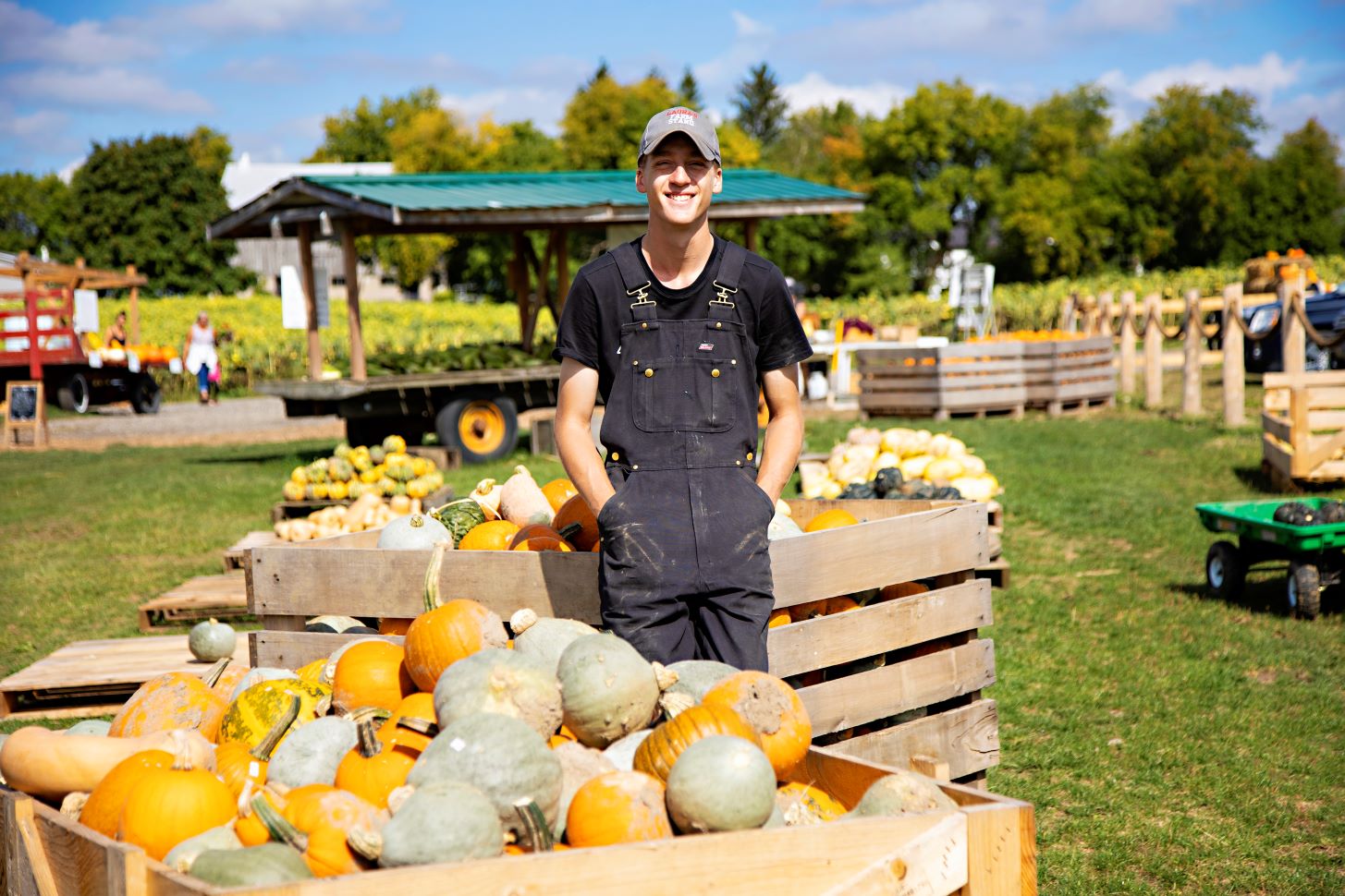 A farmer with crops at a local market. The Autumn Equinox is symbolic of the completion of harvest, usually marked by festivals like Thanksgiving (FarmPhotos.ca)