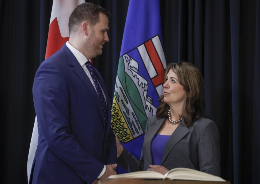 Alberta Premier Danielle Smith, right, stands with new Minister of Jobs, Economy, Trade, and Immigration, Joseph Schow, following a swearing in ceremony in Calgary, Alta., Friday, May 16, 2025.THE CANADIAN PRESS/Jeff McIntosh