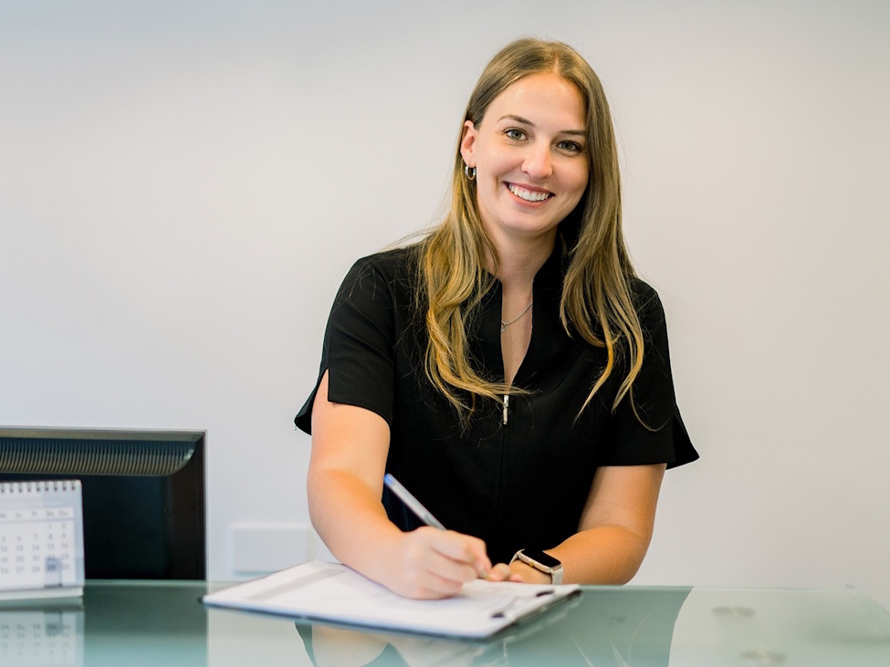a young lady sitting at a desk