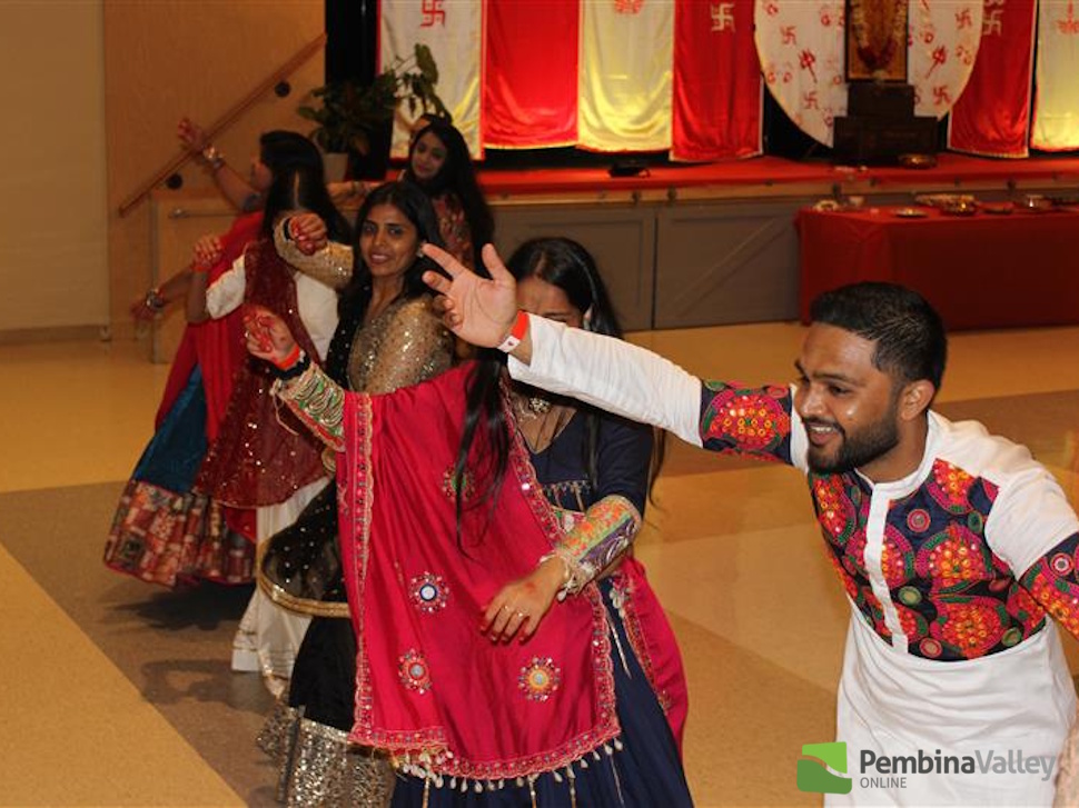 people dancing wearing traditional Garba clothing