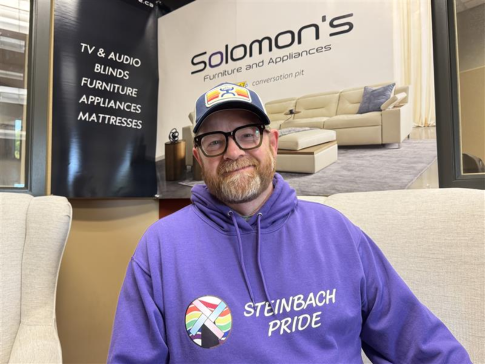 Chris Plett, president of Steinbach Pride in the MIX 96 studio, furnished by Solomon's in Steinbach.